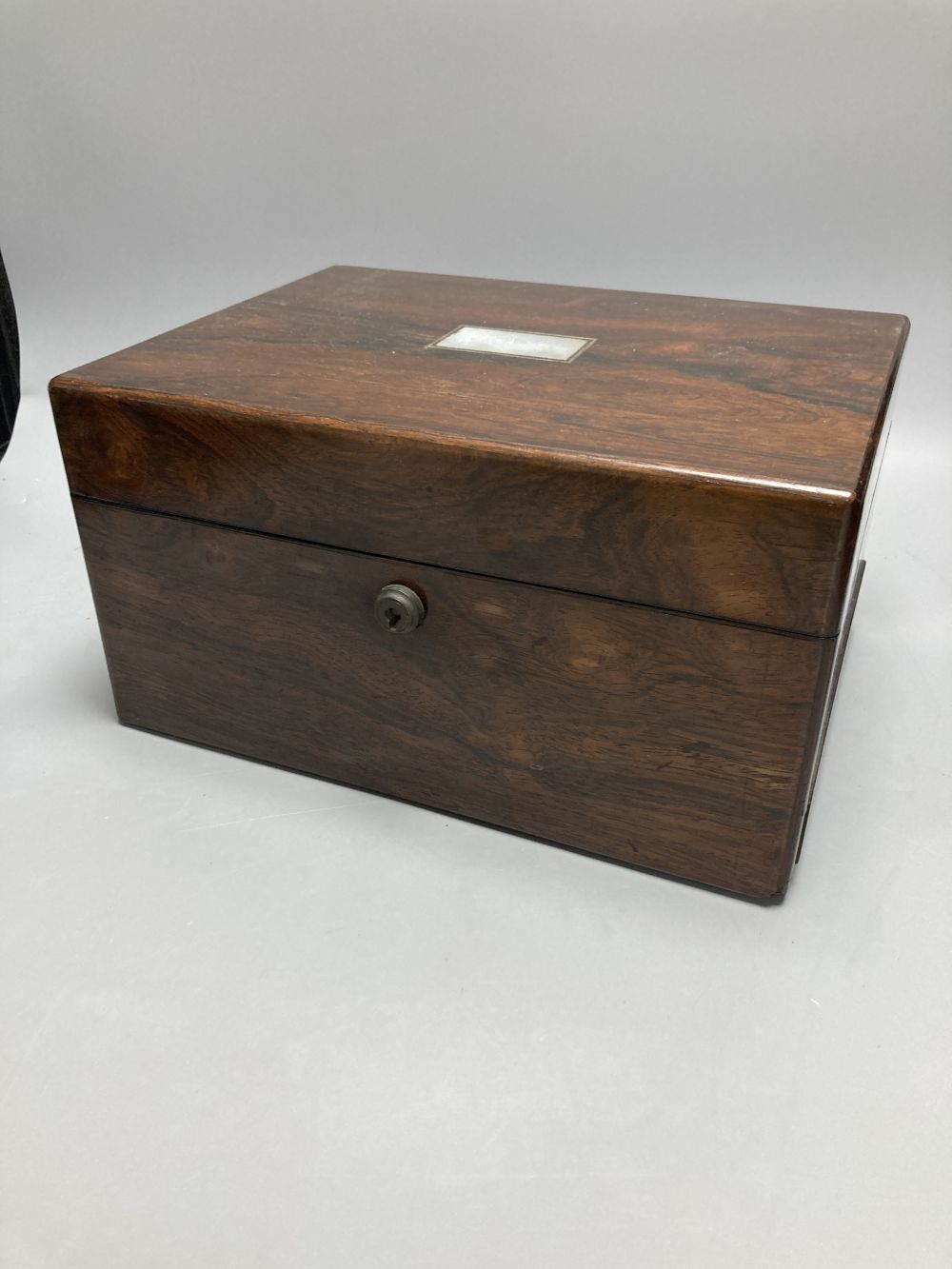 A Victorian rosewood dressing case, with mother of pearl entablature and plate-mounted glass fitments, width 30cm, depth 23cm, height 1